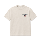 Flock Off Tee in natural, front: JIMMY BALLS with a small full-color American flag on the left chest