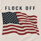 Close-up of the FLOCK OFF and full-color waving flag back print on the natural tee